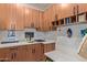 Well-organized mud room features custom wood cabinets, white countertops, a sink, and bench seating at 15827 E Firerock County Club Dr, Fountain Hills, AZ 85268