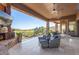 Relaxing outdoor space features comfortable seating, a fireplace, and panoramic views of the golf course at 15827 E Firerock County Club Dr, Fountain Hills, AZ 85268