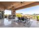 Expansive covered patio offering stunning views, a fireplace, a TV, and comfortable seating at 15827 E Firerock County Club Dr, Fountain Hills, AZ 85268