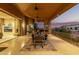 Inviting outdoor dining area on a covered patio, complete with a stone fireplace and stunning desert views at 15827 E Firerock County Club Dr, Fountain Hills, AZ 85268