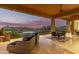 Expansive patio featuring comfortable seating, dining area, and picturesque views of the lake and mountains at 15827 E Firerock County Club Dr, Fountain Hills, AZ 85268