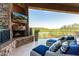Outdoor patio featuring a stone fireplace, lounge chairs, and panoramic views at 15827 E Firerock County Club Dr, Fountain Hills, AZ 85268