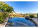 Infinity pool with serene views of the surrounding landscape and clear blue sky at 15827 E Firerock County Club Dr, Fountain Hills, AZ 85268