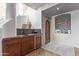 Attractive wet bar features rich wood cabinetry, granite counters, and a convenient beverage refrigerator at 15827 E Firerock County Club Dr, Fountain Hills, AZ 85268
