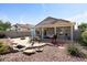 A delightful backyard featuring a covered patio and outdoor dining area, perfect for entertaining at 15876 W Alpine Ridge Dr, Surprise, AZ 85374