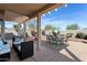 Outdoor living space with patio, desert landscaping, seating, dining areas and barbeque at 15876 W Alpine Ridge Dr, Surprise, AZ 85374