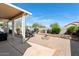Outdoor living space with patio, desert landscaping, waterfall feature, seating and dining areas at 15876 W Alpine Ridge Dr, Surprise, AZ 85374