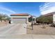 Charming single-story home with tile roof, landscaped front yard, and an attached two-car garage at 15876 W Alpine Ridge Dr, Surprise, AZ 85374