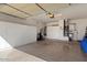 Spacious garage with ample storage cabinets, utility sink, and well-organized layout at 15876 W Alpine Ridge Dr, Surprise, AZ 85374