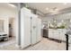 Open concept kitchen with white cabinets, stainless steel appliances and light wood floors at 15876 W Alpine Ridge Dr, Surprise, AZ 85374