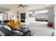 Open-concept living room with fireplace, modern decor, and sliding glass doors to a patio at 15876 W Alpine Ridge Dr, Surprise, AZ 85374