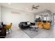 Stylish living room with modern decor, open to kitchen, lots of natural light, and neutral flooring at 15876 W Alpine Ridge Dr, Surprise, AZ 85374