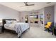 Bright main bedroom with a ceiling fan, carpet floors, and multiple windows with natural light at 15876 W Alpine Ridge Dr, Surprise, AZ 85374