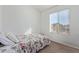 Cozy bedroom with a floral bedspread and natural light from a window at 1601 N Saba St # 264, Chandler, AZ 85225