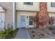 Charming townhome featuring a walkway to the front door, mature shrubbery, and red brick details at 1601 N Saba St # 264, Chandler, AZ 85225