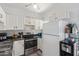 Efficient kitchen featuring white cabinets, stainless steel appliances, and ample counter space at 1601 N Saba St # 264, Chandler, AZ 85225
