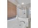 Bright bathroom featuring a soaking tub with a large window and a glass-enclosed shower at 16247 W Desert Mirage Dr, Surprise, AZ 85379
