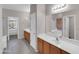Spacious bathroom features double vanity, tiled floor, and separate tub and shower at 16247 W Desert Mirage Dr, Surprise, AZ 85379