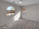 Bedroom featuring carpeted floors and a large arched window at 16247 W Desert Mirage Dr, Surprise, AZ 85379
