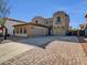 Stunning two-story home featuring a three-car garage and a spacious driveway with beautiful brick accents at 16247 W Desert Mirage Dr, Surprise, AZ 85379