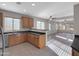 Kitchen features stainless steel appliances, tile floors, and dark countertops at 16247 W Desert Mirage Dr, Surprise, AZ 85379