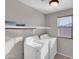 Laundry room features a washer, dryer, and storage shelf at 16247 W Desert Mirage Dr, Surprise, AZ 85379