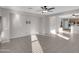 Open-concept living room with ceiling fan, and open access to kitchen at 16247 W Desert Mirage Dr, Surprise, AZ 85379