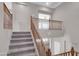 This carpeted stairway has a wooden banister and light gray walls at 16247 W Desert Mirage Dr, Surprise, AZ 85379