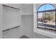 Walk-in closet with shelving, hanging rods, and a window at 16247 W Desert Mirage Dr, Surprise, AZ 85379