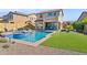 Expansive backyard showcasing a pool with a spa, outdoor kitchen, and well-manicured lawn at 1646 N Channing --, Mesa, AZ 85207