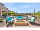 Inviting backyard with a fire pit, comfortable seating, a sparkling pool, and a desert view at 1646 N Channing --, Mesa, AZ 85207