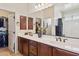 Bathroom with double sink vanity, decorative mirror, and closet at 1646 N Channing --, Mesa, AZ 85207