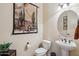 Bathroom with pedestal sink, decorative mirror, and framed cactus art on the wall at 1646 N Channing --, Mesa, AZ 85207