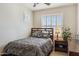 Relaxing bedroom features a bed, shutters on the window, a ceiling fan and decor at 1646 N Channing --, Mesa, AZ 85207