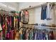 Walk-in closet with ample hanging space, shelving, and organized clothing racks for convenient storage at 1646 N Channing --, Mesa, AZ 85207