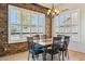Bright dining room featuring stone accent wall, modern lighting fixture, and outdoor views at 1646 N Channing --, Mesa, AZ 85207