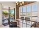 Dining room featuring stone accent wall, modern lighting fixture, and glass doors to the patio at 1646 N Channing --, Mesa, AZ 85207