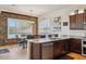 Modern kitchen featuring dark cabinets, granite countertops, and an adjacent dining area at 1646 N Channing --, Mesa, AZ 85207