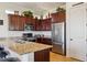 Well-appointed kitchen with dark wood cabinets, stainless appliances, and granite countertops at 1646 N Channing --, Mesa, AZ 85207