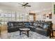 Spacious living room with a large sectional, plantation shutters, and ceiling fan at 1646 N Channing --, Mesa, AZ 85207
