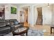 Cozy living room showcasing tile floors, a leather sectional, and staircase access at 1646 N Channing --, Mesa, AZ 85207