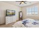 Bright main bedroom with television, dresser, mirror, and carpeted floors at 1646 N Channing --, Mesa, AZ 85207