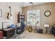 Office space with dark wood desk, guitars, and a ceiling fan in a carpeted room at 1646 N Channing --, Mesa, AZ 85207