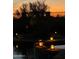 Atmospheric backyard pool lit by charming decorative lanterns at dusk at 1646 N Channing --, Mesa, AZ 85207