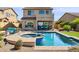 Captivating backyard featuring a pool with a spa, lounge area, and lush landscaping at 1646 N Channing --, Mesa, AZ 85207