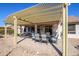Backyard patio area featuring a pergola, outdoor dining set, and grill at 16495 W Monteverde Ln, Surprise, AZ 85374