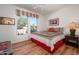 Cozy bedroom with a ceiling fan, a colorful quilt on the bed, and a view of the neighborhood at 16495 W Monteverde Ln, Surprise, AZ 85374