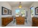 Bright dining area featuring a breakfast bar with granite countertop, a pendant light, and views of the neighborhood at 16495 W Monteverde Ln, Surprise, AZ 85374