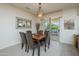 Cozy dining room with seating for six, a mirror, and sliding glass doors to the patio at 16495 W Monteverde Ln, Surprise, AZ 85374