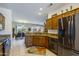 Gourmet kitchen flows into the dining area, features stainless steel appliances and custom wood cabinetry at 16495 W Monteverde Ln, Surprise, AZ 85374